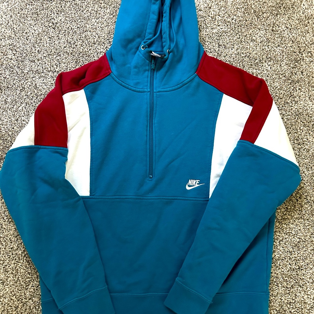 Turquoise, white and maroonish quarter zip Nike Men’s hoodie.